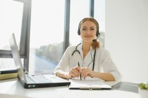 doctor talking with sick person through laptop online system and using mobile digital tablet